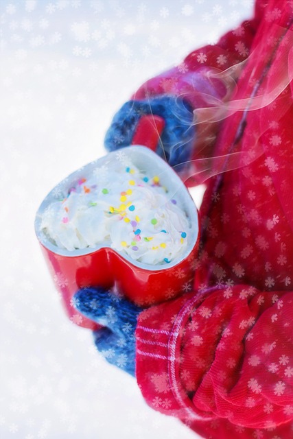 Steaming cup of rich Italian hot chocolate made with Madagascar cocoa topped with whipped cream on a marble cafe table with cacao pods in background